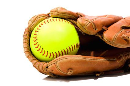 A new flourescent yellow Softball in a glove against a white background